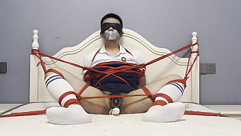 Asian boy tied to the bed,  plugged by dildo and struggled