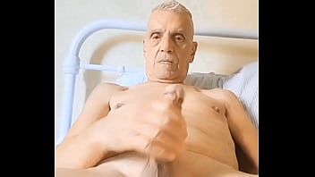 Michael Murphy propped up in bed having a wank