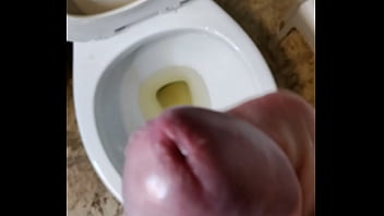 Straight guy with big uncut cock pissing while stroking then cums