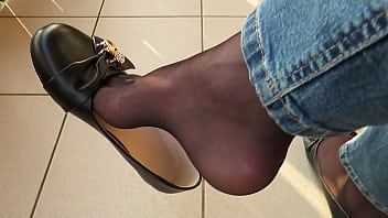 balcony shoeplay by Isabelle-Sandrine,  she wears her black leather ballet flats,  black nylons and jeans