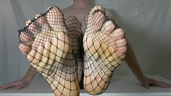 Painted red toenails in black fishnet pantyhose tights